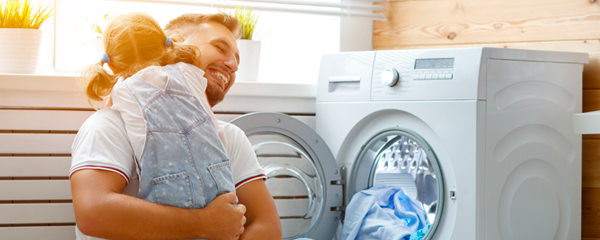 father pulling out clothes from dryer
